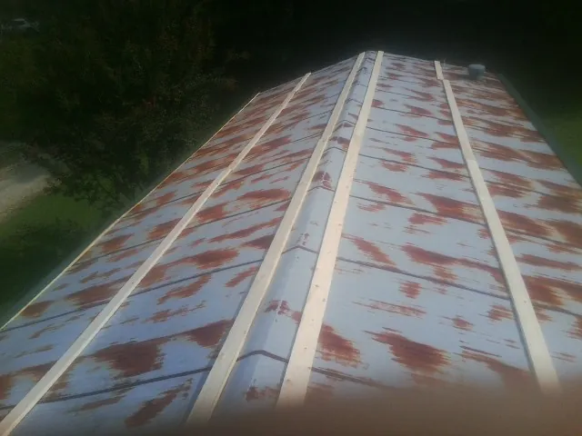Rusted metal roof panels with new wood purlins before replacement — Storm Damage Roof Repair in Olyphant by Roofing Brothers