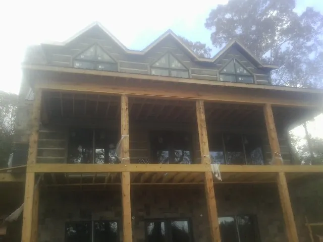Dormers and porch framing on a large log home under construction in Olyphant