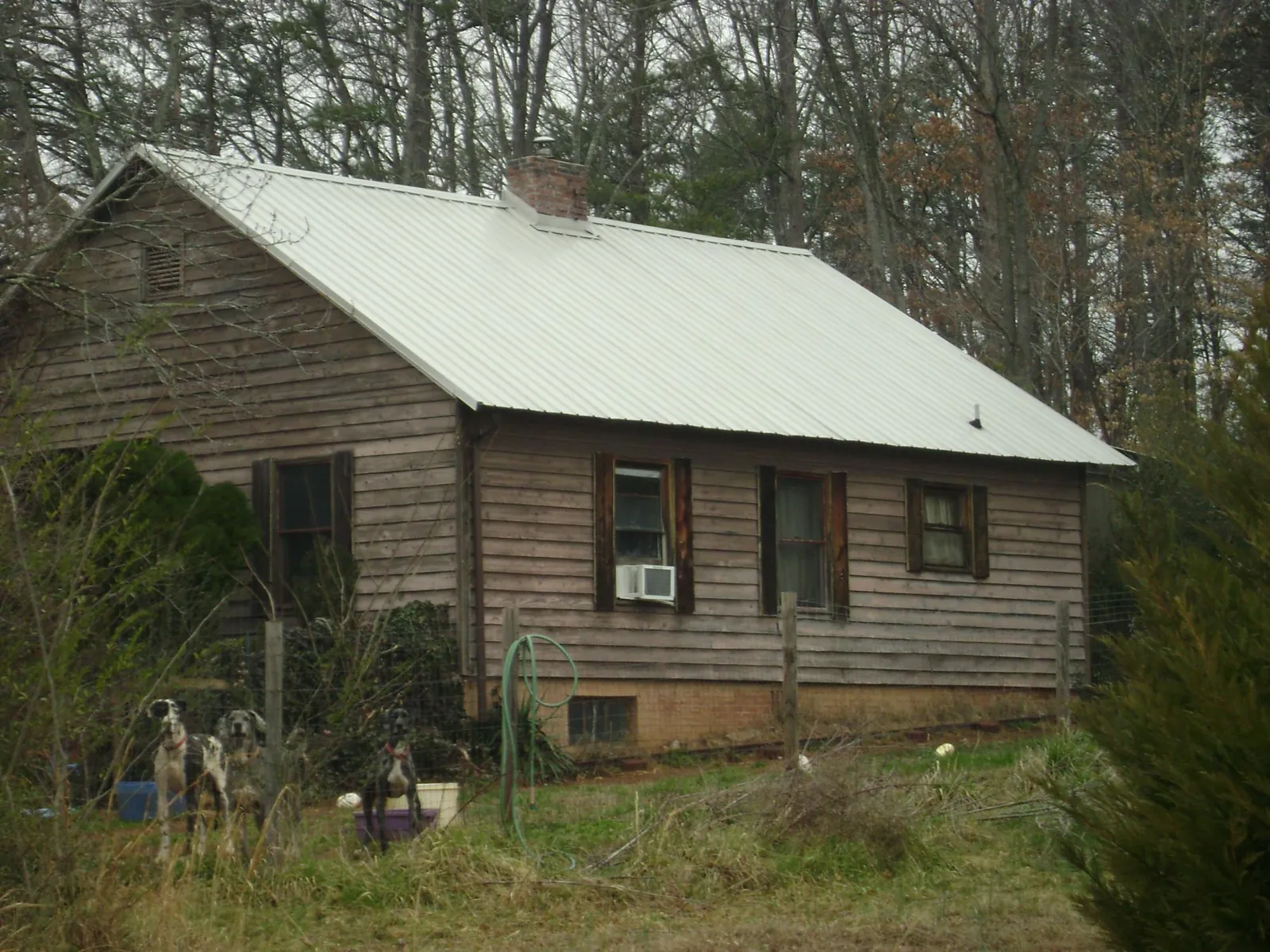 White metal roof on an old wood sided farmhouse, from a Metal Roof Installation job in Olyphant